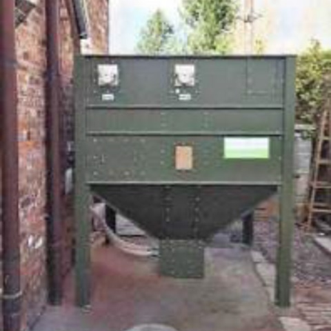 Timber-clad wood pellet storage unit for discreet, aesthetic biomass fuel protection in south west scotland.